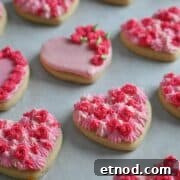Valentine Sugar Cookies with Creamy Buttercream Frosting 12 Soft Valentine heart cookies with thick buttercream frosting piped in shades of pink.