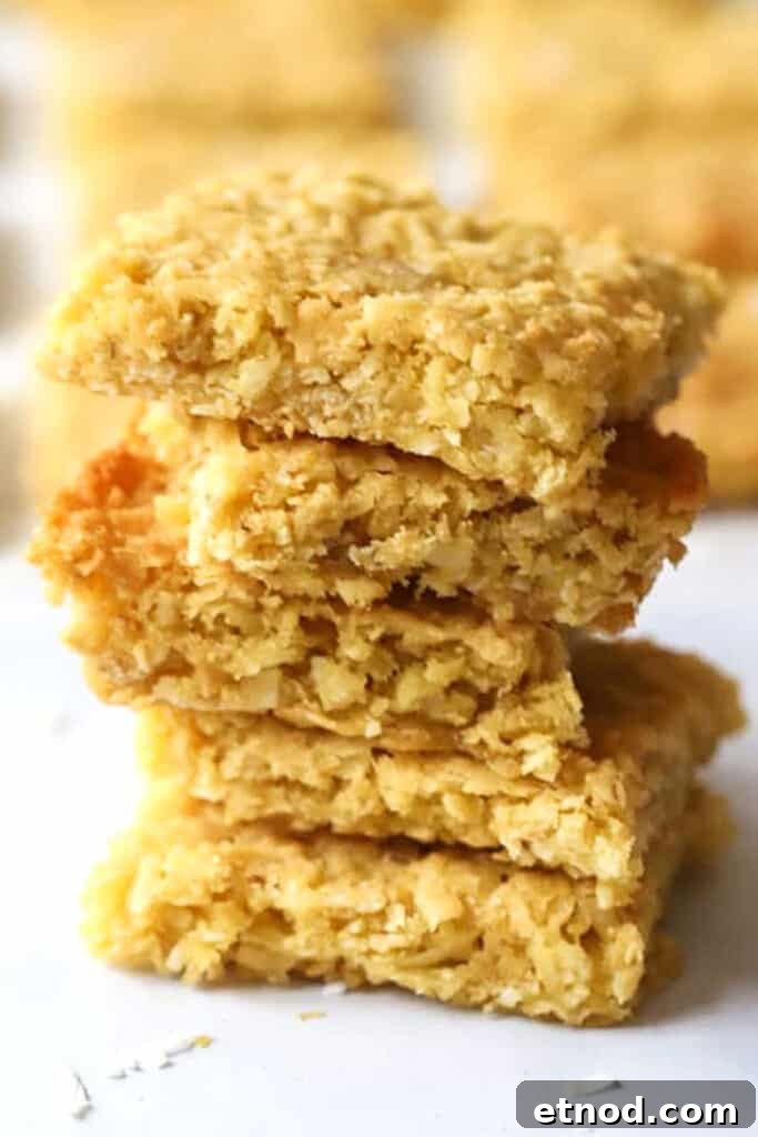 Chewy Coconut Cookie Bars Recipe for Summer Baking 4 Coconut cookie bars stacked on top of each other.