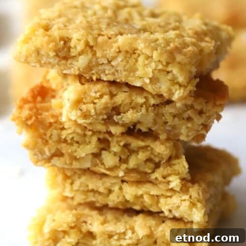 Chewy Coconut Cookie Bars Recipe for Summer Baking 5 coconut cookie bars stacked on top of each other