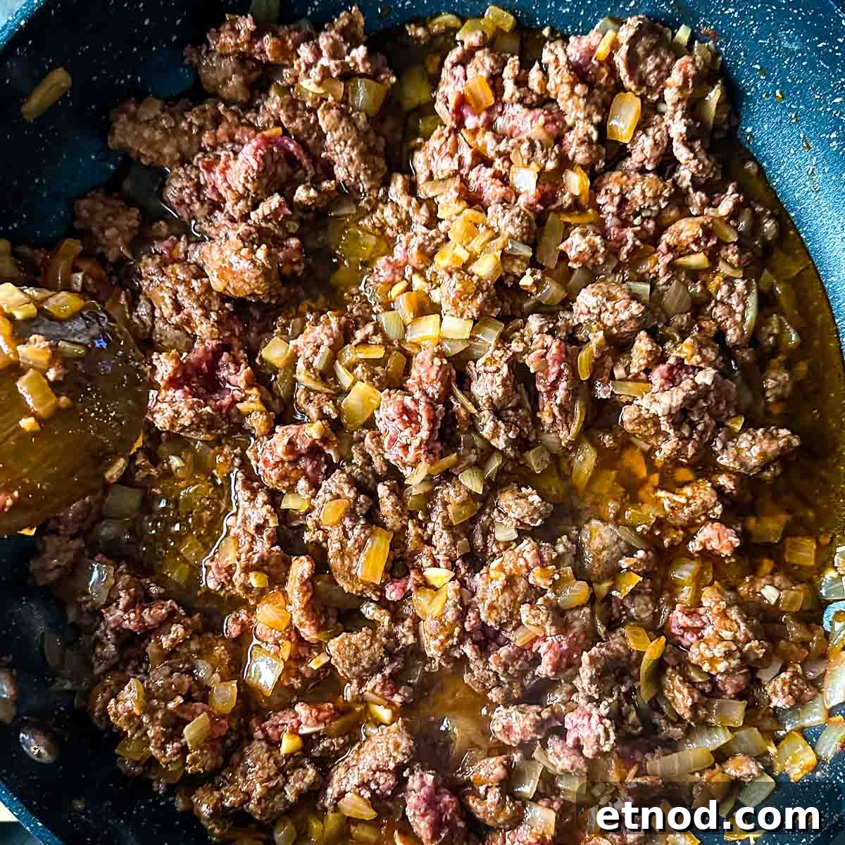 browned lamb with onion, garlic, tomato paste, and chili flakes.