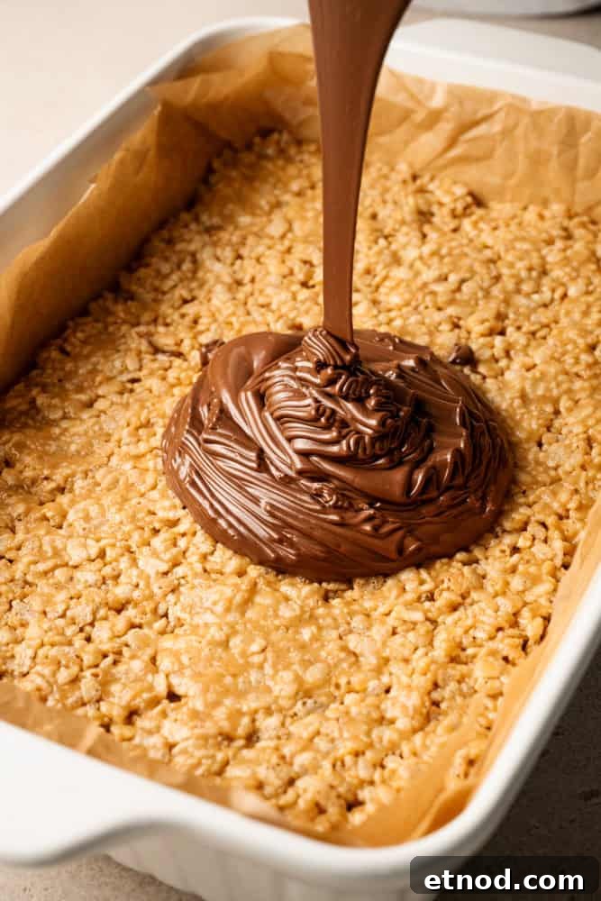 Chocolate being poured over the cereal mixture.
