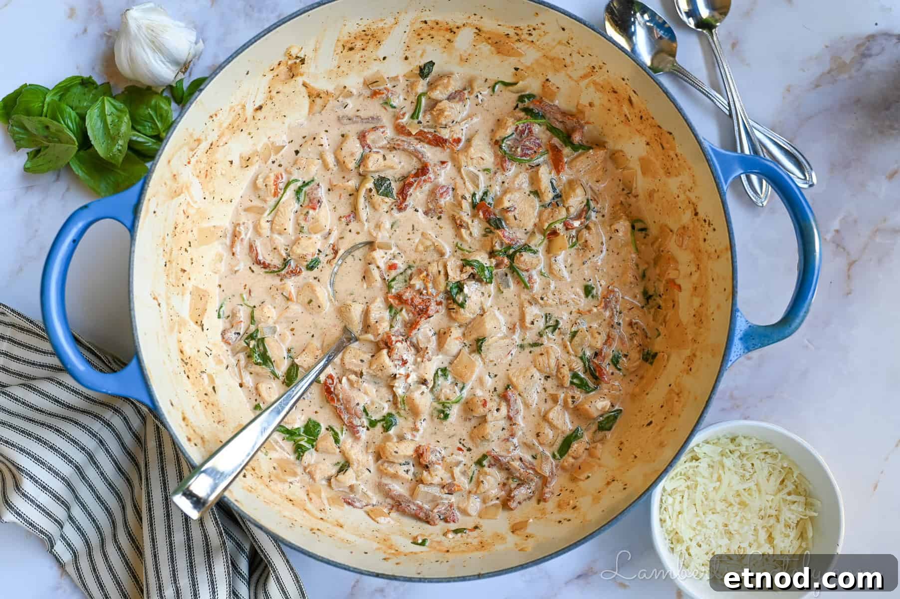 Marry Me Chicken Soup Recipe That Wins Hearts 2 marry me chicken soup in a large pot, surrounded by bowls of parmesan cheese, basil, garlic.