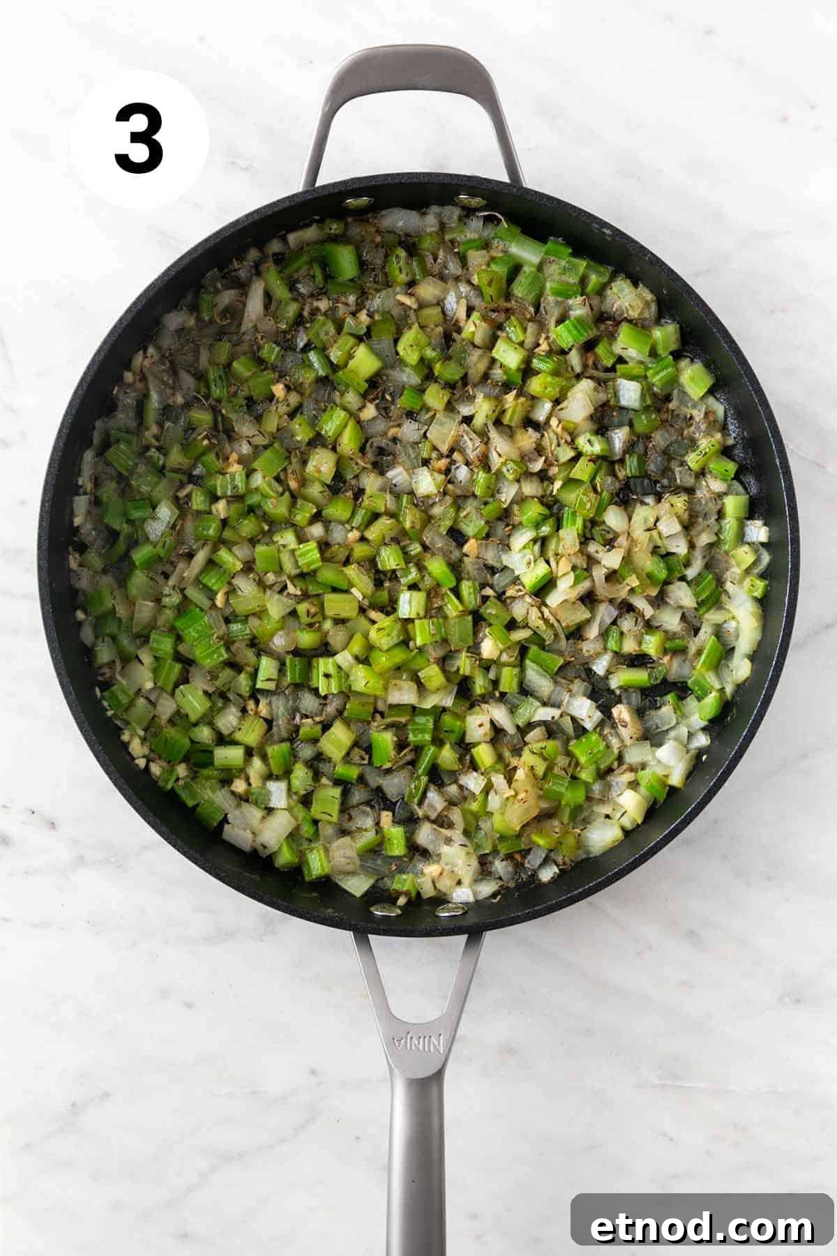 Sauteed veggies and spices in a skillet.