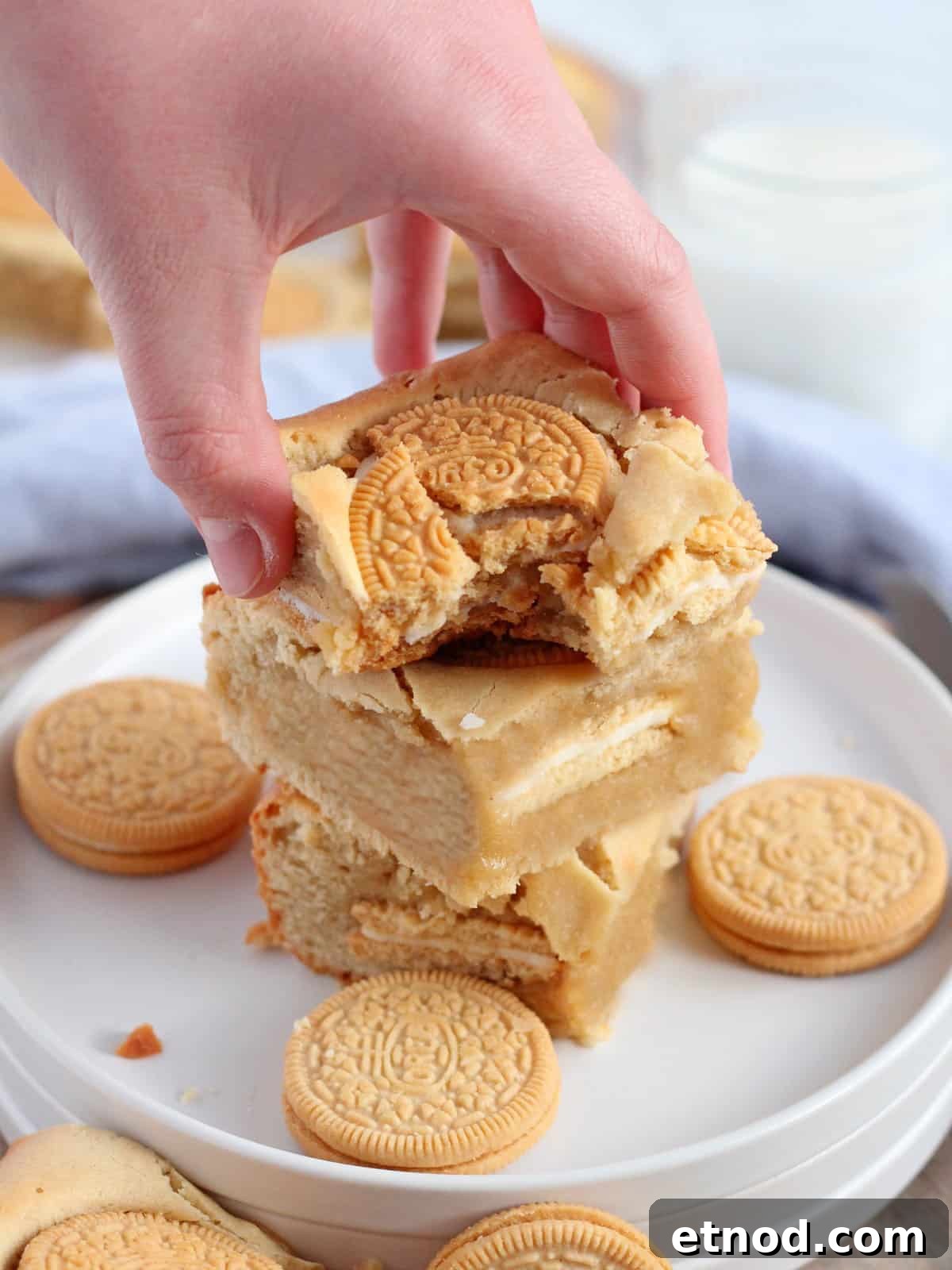 Golden Oreo Blondies Recipe: Chewy Vanilla Oreo Blondies 14 Golden oreo blondies bar in hand, with a bite, close up