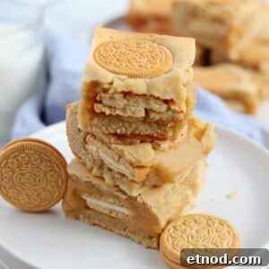 Golden Oreo Blondies Recipe: Chewy Vanilla Oreo Blondies 16 pile of golden oreo blondies on white plate with oreo cookies around