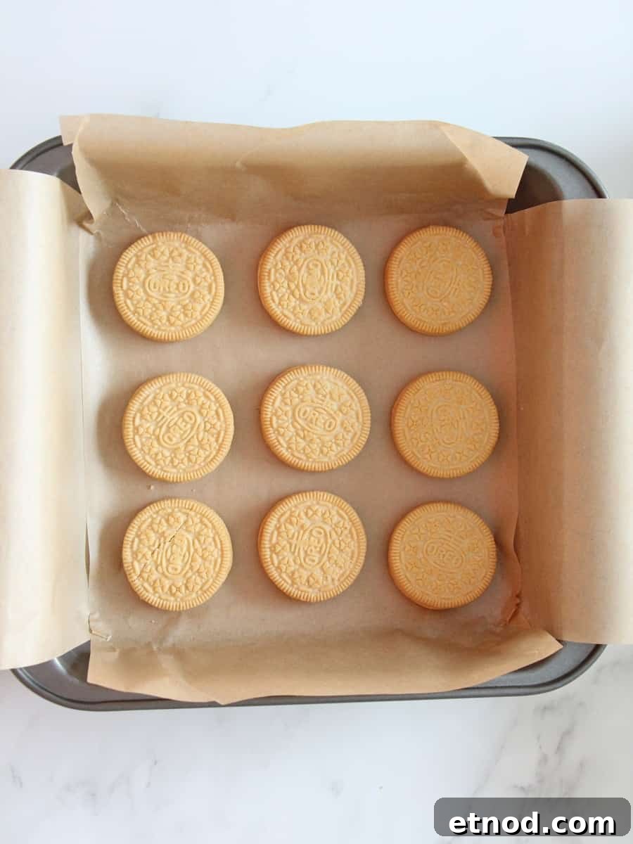 Golden Oreo Blondies Recipe: Chewy Vanilla Oreo Blondies 8 Baking pan with parchment paper and nine Oreo cookies place carefully inside the pan