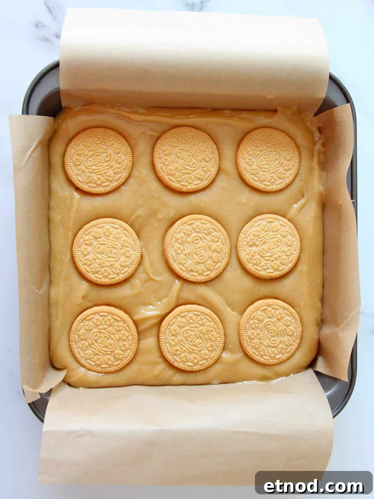 Golden Oreo Blondies Recipe: Chewy Vanilla Oreo Blondies 10 Fresh batter for oreo blondies spreaded in the pan and topped with nine golden oreo cookies