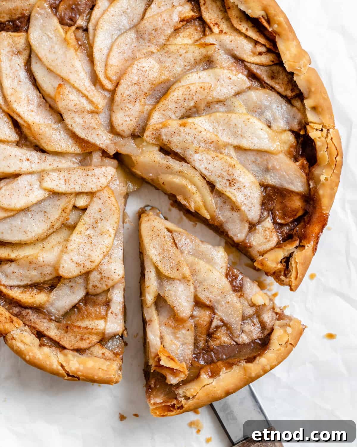Apple and Pear Pie Recipe with Cinnamon Crumble 8 completed Easy Apple Pear Pie with a slice cut out against a white surface