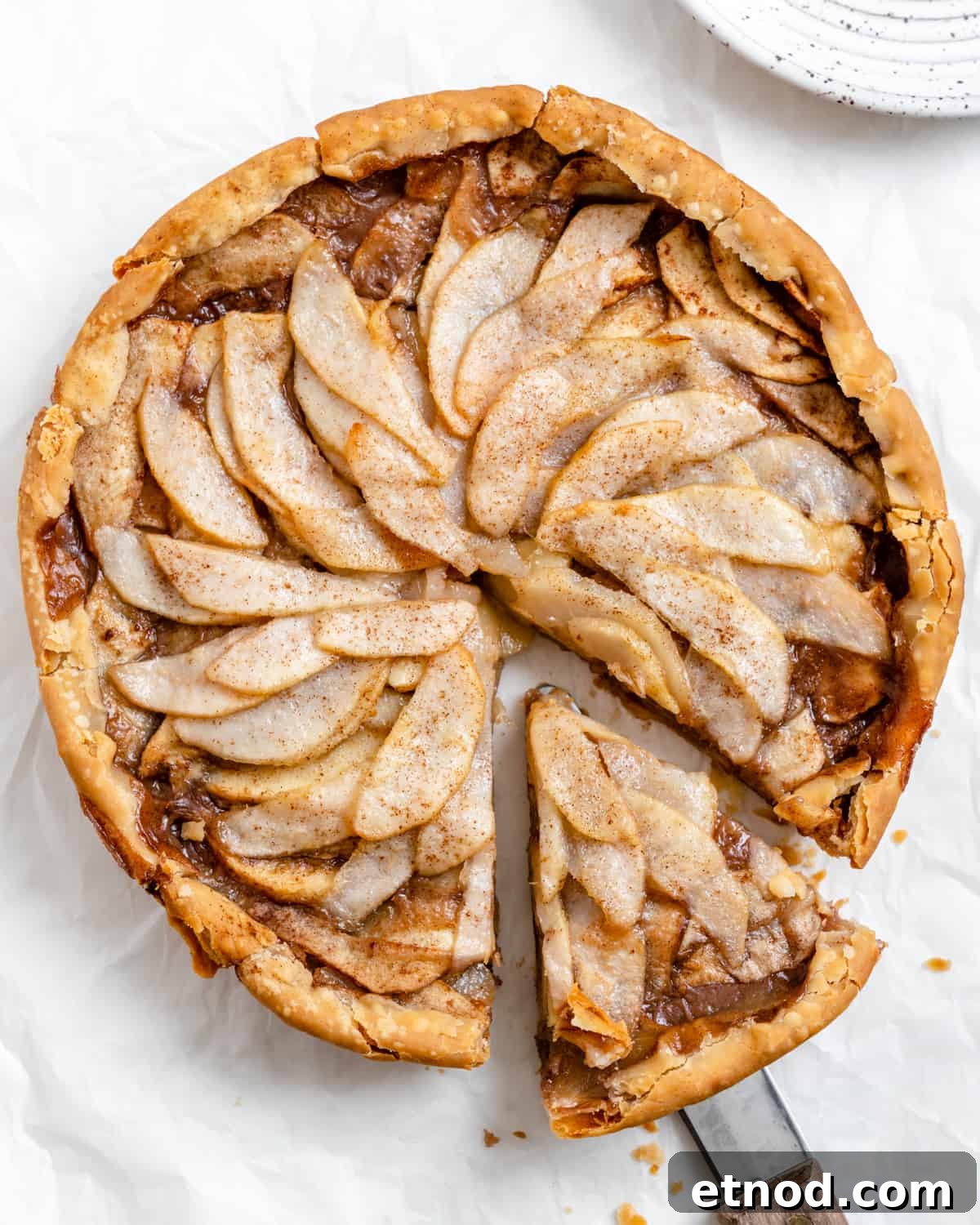 Apple and Pear Pie Recipe with Cinnamon Crumble 9 completed Easy Apple Pear Pie with a slice cut out against a white surface