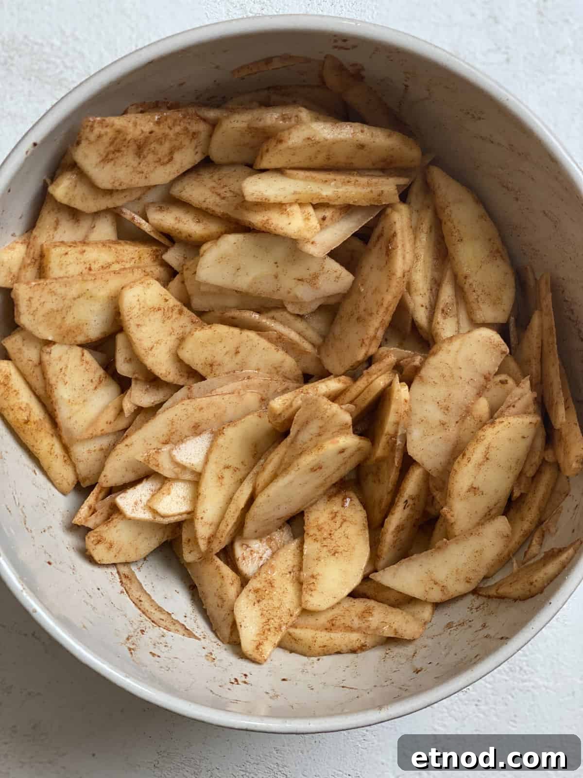 Apple and Pear Pie Recipe with Cinnamon Crumble 5 sliced fruits and filling ingredients in a bowl