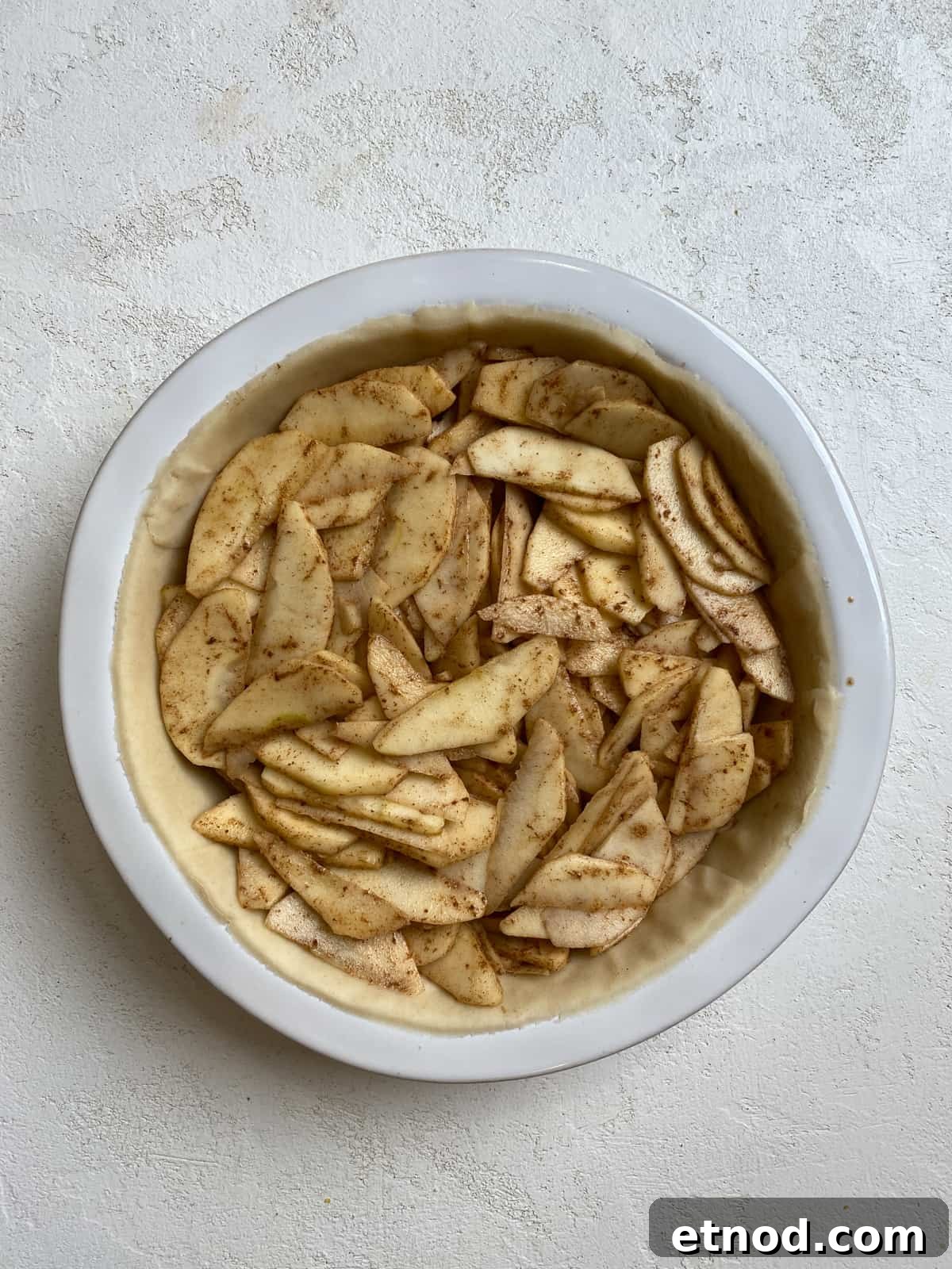 Apple and Pear Pie Recipe with Cinnamon Crumble 7 process shot of Easy Apple Pear Pie ingredients in a pie crust against a white surface