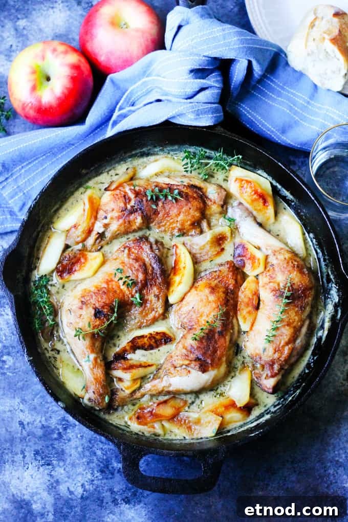Braised Chicken Normandy with Apple Cider and Brandy 22 Chicken normandy with apples in a cast iron skillet.