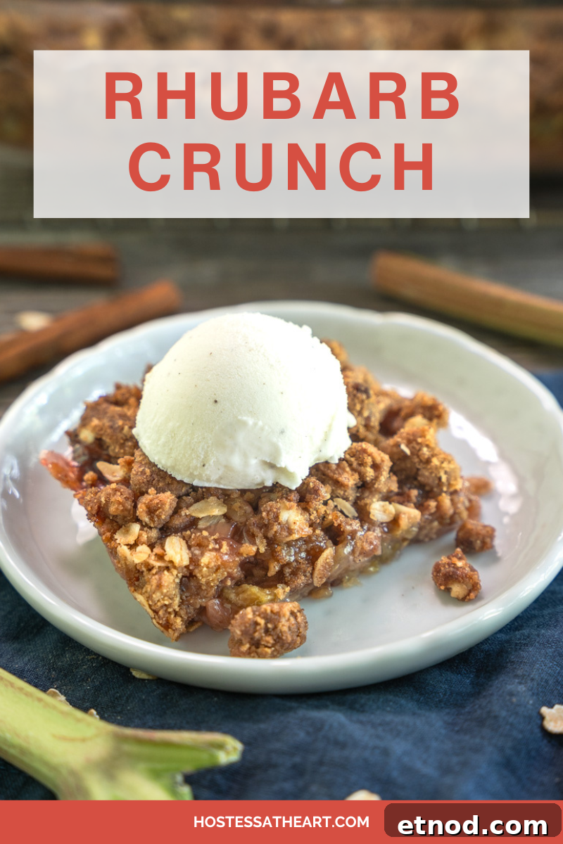 Old-Fashioned Rhubarb Crunch Recipe — Classic Homestyle Dessert 14 Angled view of a slice of rhubarb crisp topped with vanilla bean ice cream - Hostess At Heart