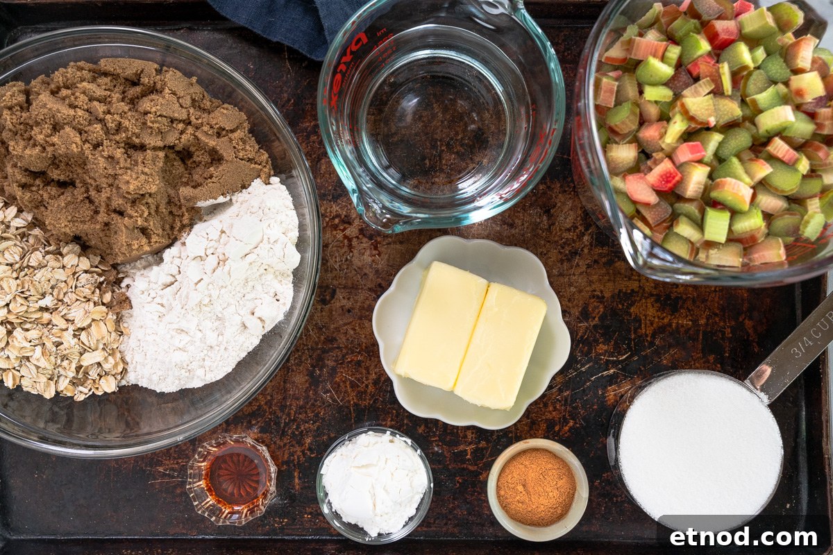Old-Fashioned Rhubarb Crunch Recipe — Classic Homestyle Dessert 3 Top down view of ingredients used to make rhubarb crunch including brown and white sugar, flour, cinnamon, butter, vanilla, oats, rhubarb, cornstarch, and water.