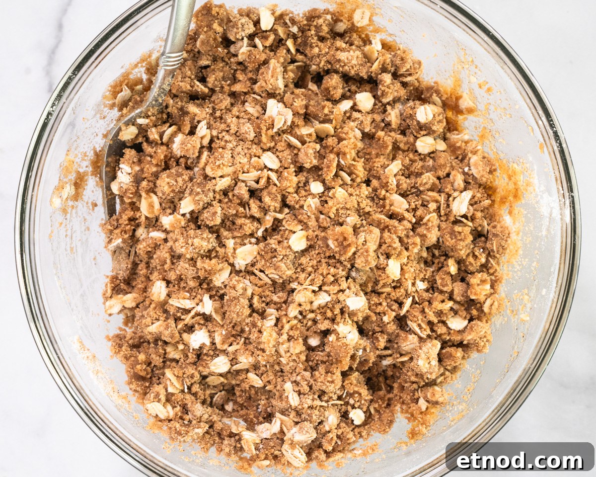 Old-Fashioned Rhubarb Crunch Recipe — Classic Homestyle Dessert 8 Top down view of a bowl filled with oat crumble topping - Hostess At Heart