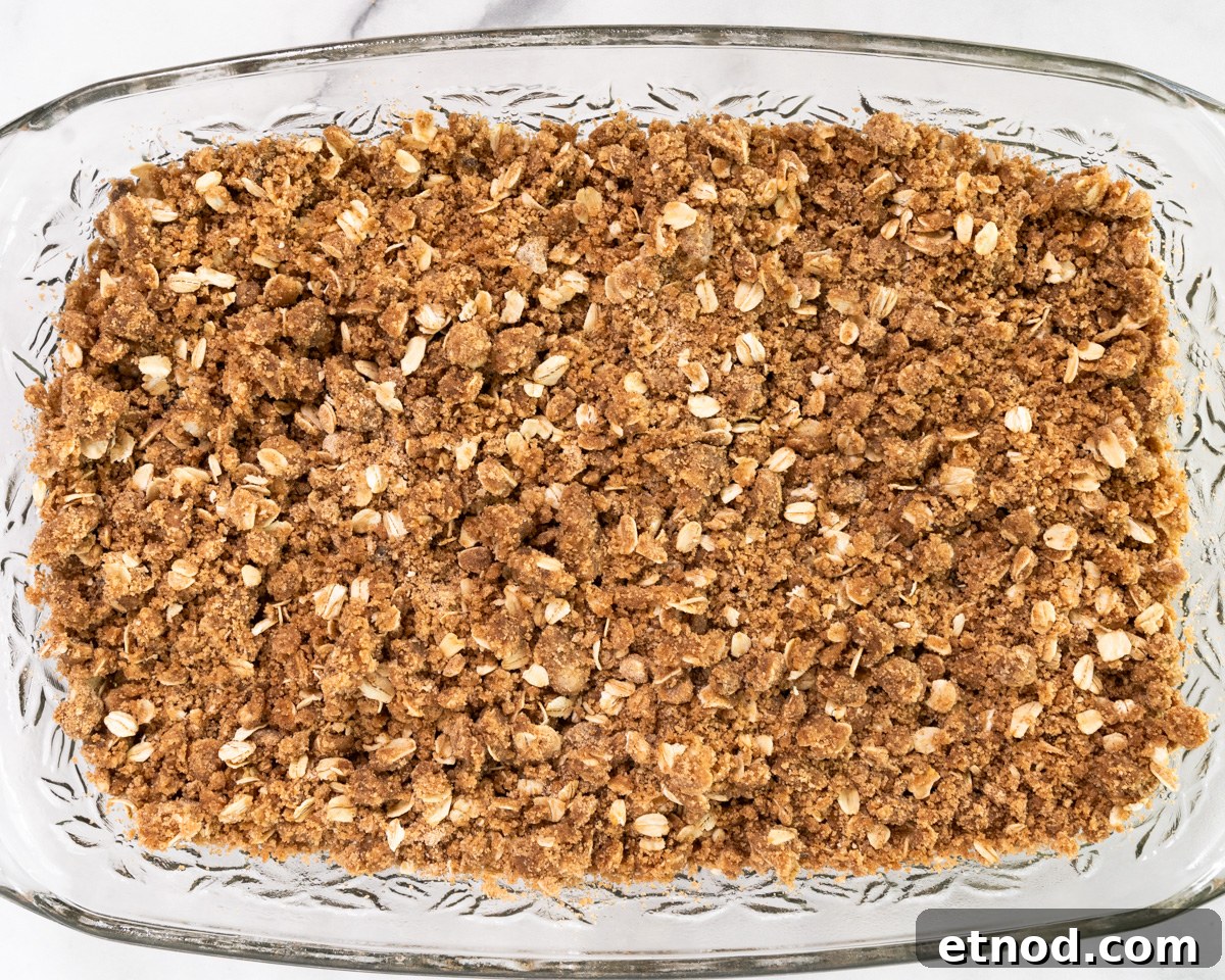 Old-Fashioned Rhubarb Crunch Recipe — Classic Homestyle Dessert 9 Top down view of a pan of baked rhubarb crisp with oat crumble topping - Hostess At Heart