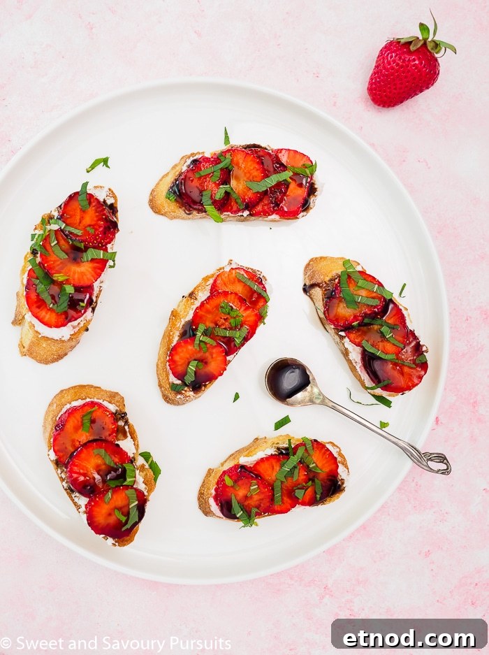 Strawberry and Goat Cheese Crostini Recipe for Summer Entertaining 2 Strawberry Goat Cheese Crostini drizzled with a balsamic reduction on a plate.