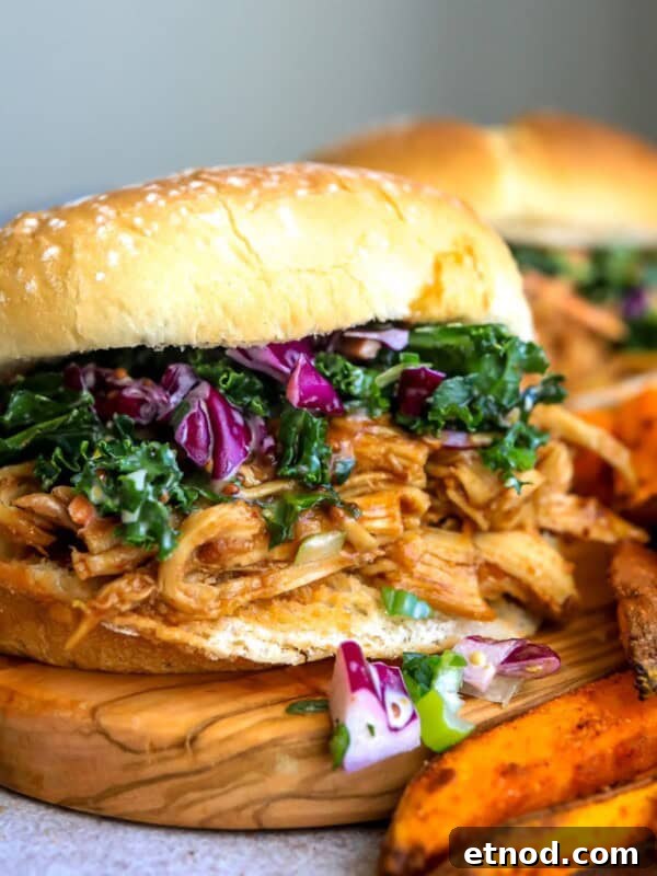 Chicken burgers up close with coleslaw and fries.