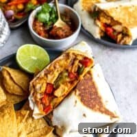 Fajita mix wrapped in a tortilla with salsa.