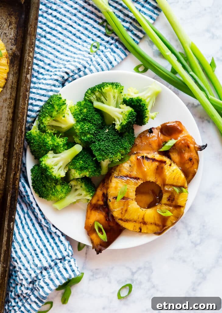 Hawaiian Aloha Chicken Recipe with Pineapple and Teriyaki Glaze 3 An overhead image of Hawaiian chicken on a plate with broccoli.