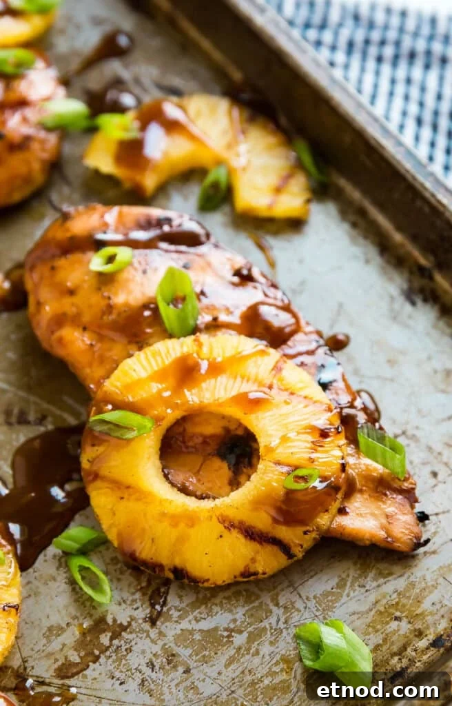 Hawaiian Aloha Chicken Recipe with Pineapple and Teriyaki Glaze 9 Grilled Hawaiian Chicken on a pan with pineapple and a drizzle of sauce.