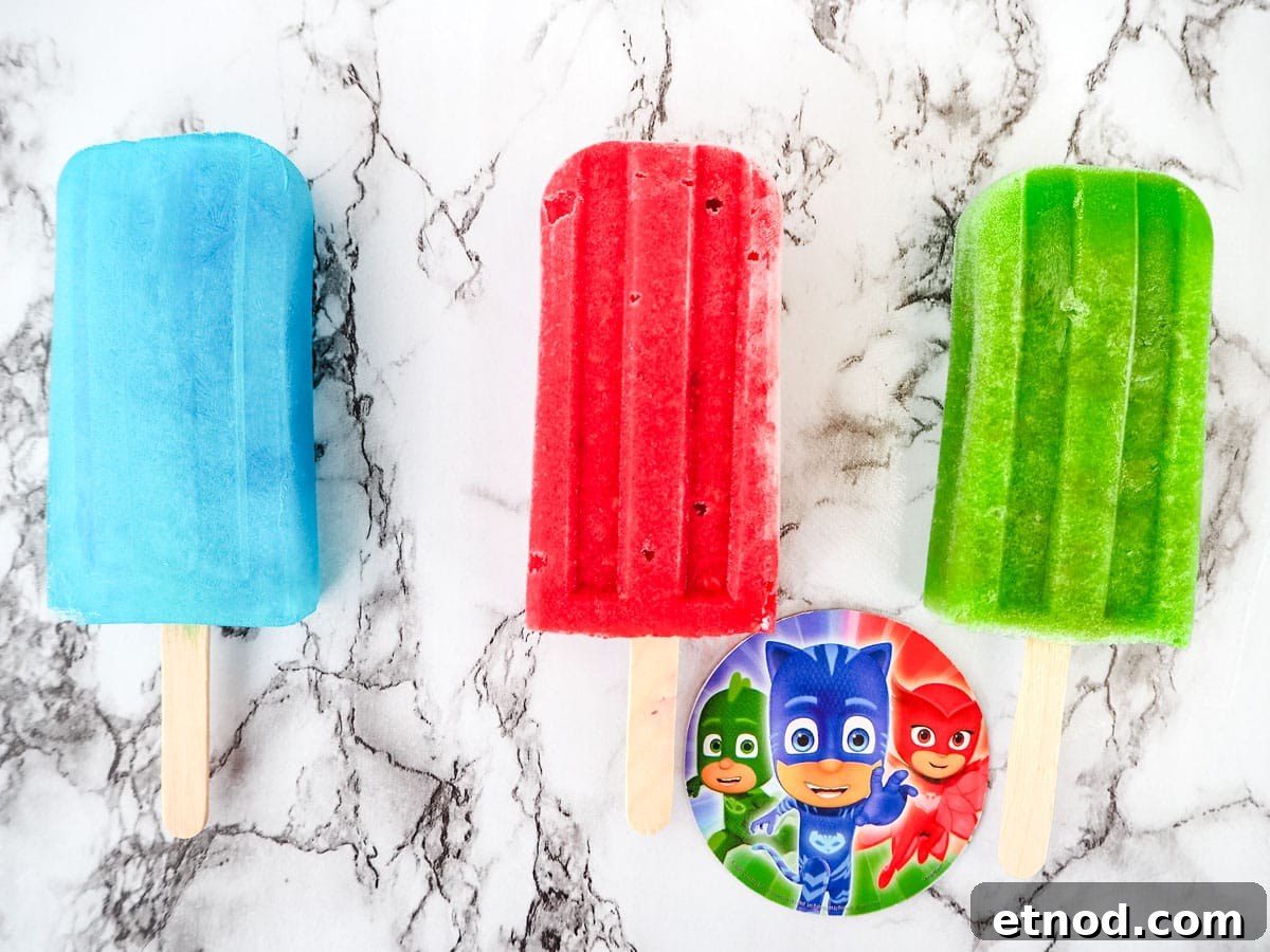 PJ Masks-Inspired Popsicle Recipes Kids Will Love 2 PJ Masks popsicles, blue lemonade, strawberry raspberry and green grape.