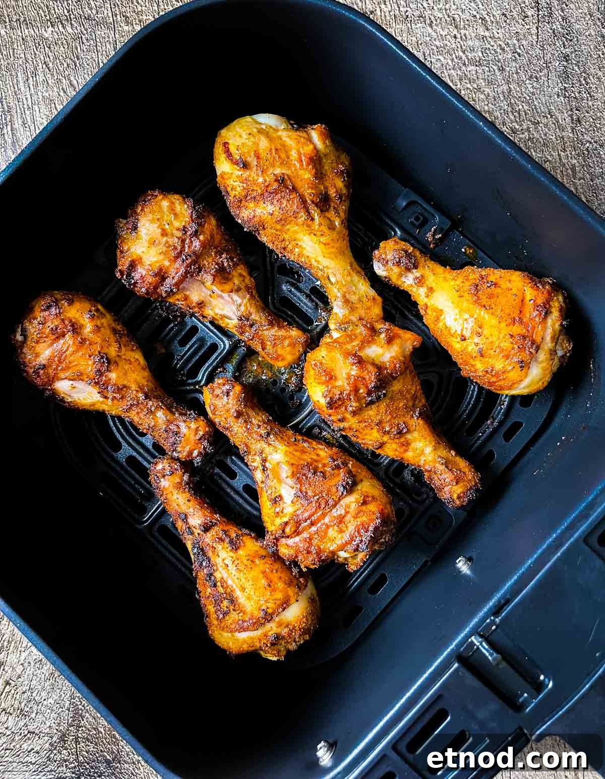 Crispy Air Fryer Chicken Drumsticks — Quick Weeknight Recipe 12 A closeup of the chicken legs completely cooked in the air fryer until golden brown and crispy.