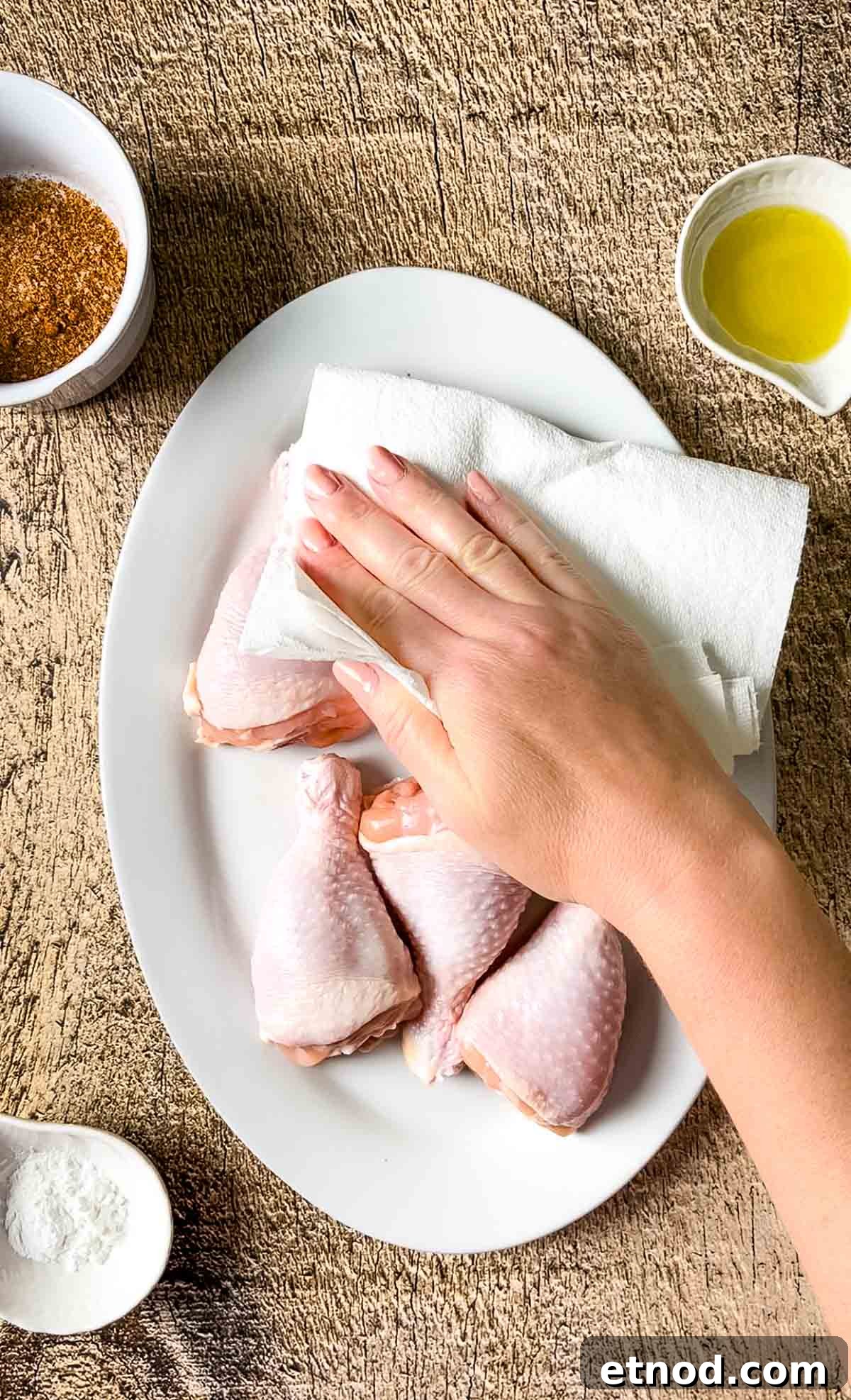 Crispy Air Fryer Chicken Drumsticks — Quick Weeknight Recipe 4 A hand drying the chicken legs with a paper towel.