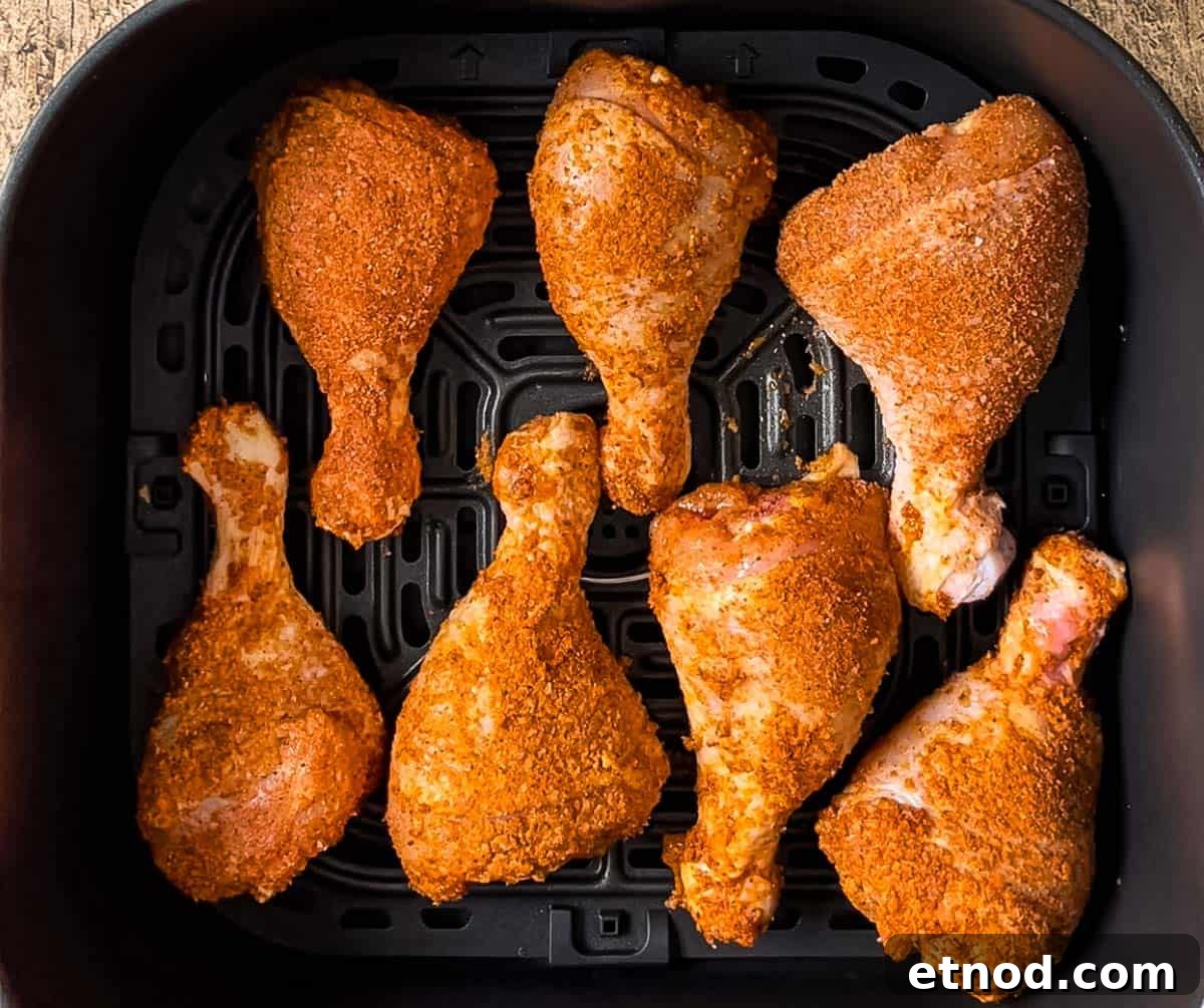 Crispy Air Fryer Chicken Drumsticks — Quick Weeknight Recipe 10 The prepared chicken legs placed