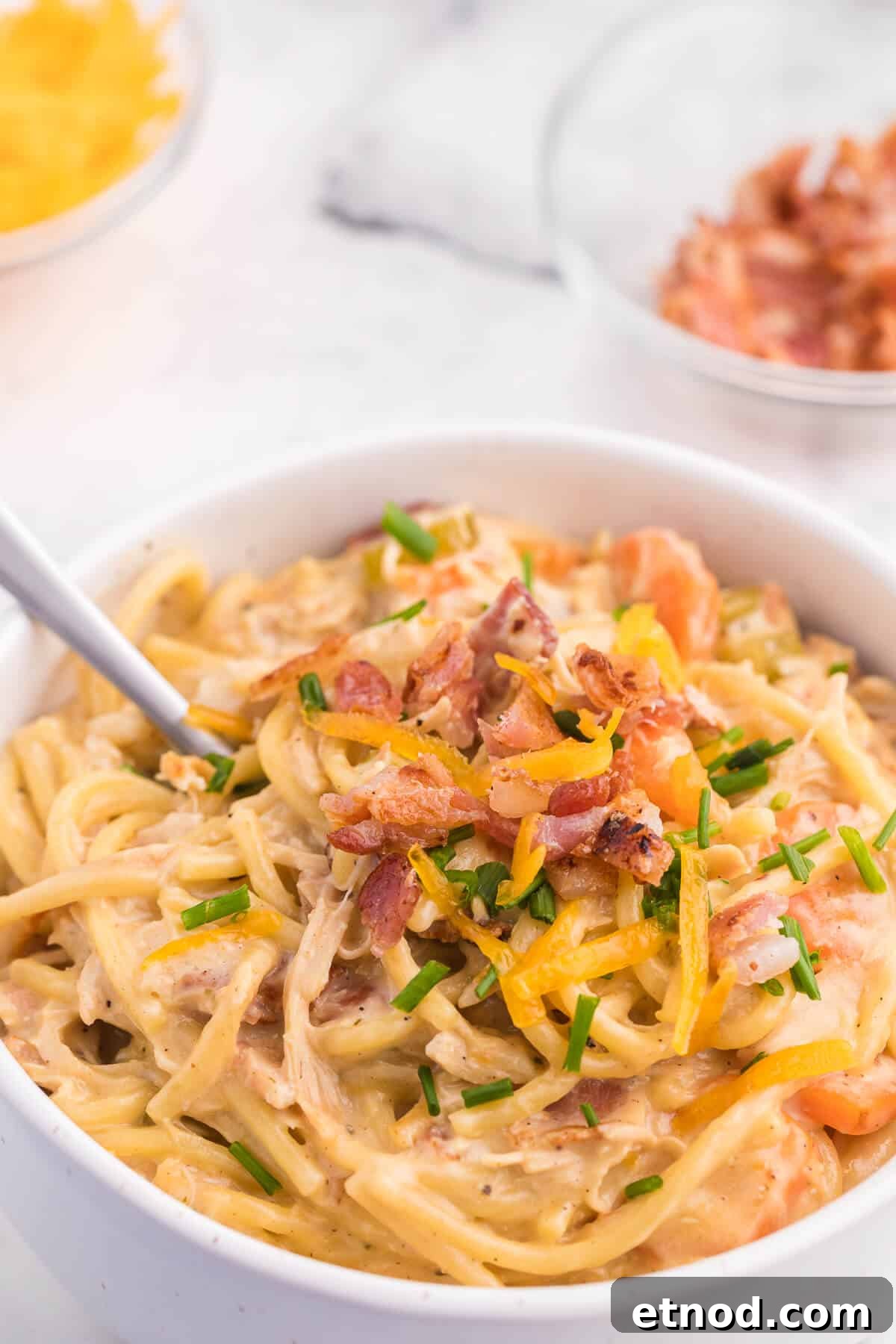 Crack Chicken Spaghetti Recipe - One bite and you'll be hooked! This easy and delicious dinner recipe is creamy, cheesy and addictive. It's loaded with chicken, bacon, veggies and spaghetti noodles in a flavorful cream cheese based sauce.