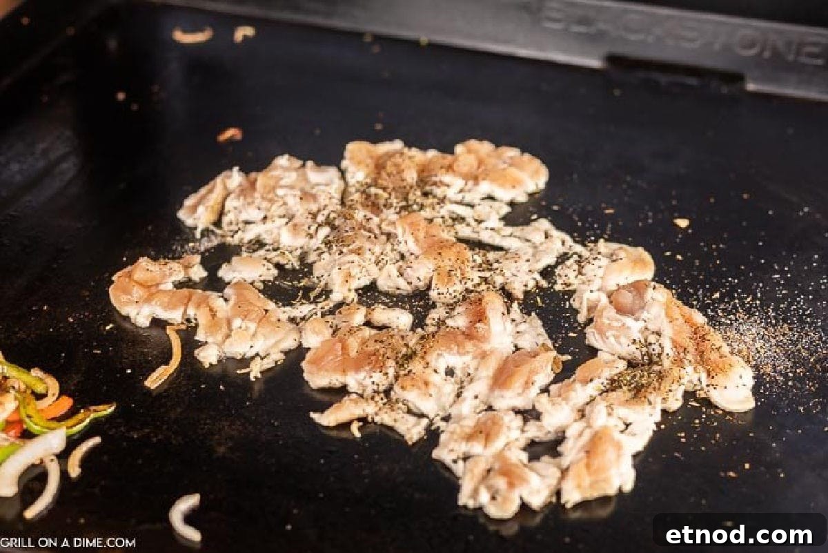 Blackstone Philly Cheesesteak Chicken Sandwich Recipe 6 Cooking chicken on the griddle.