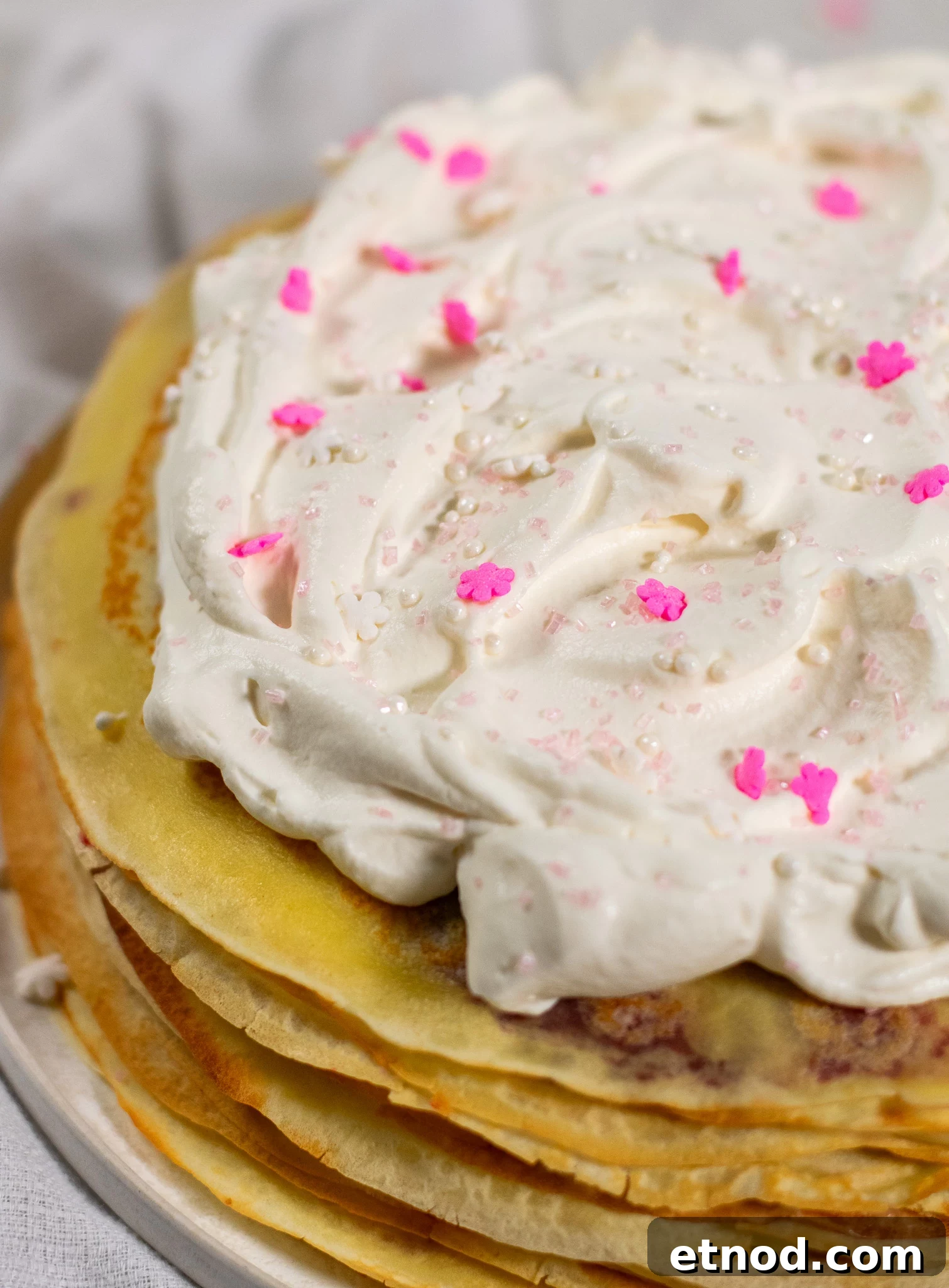 Vanilla and Raspberry Pancake Layer Cake Recipe 4 A pancake layer cake with vanilla pastry cream and raspberry jam, topped with whipped cream.
