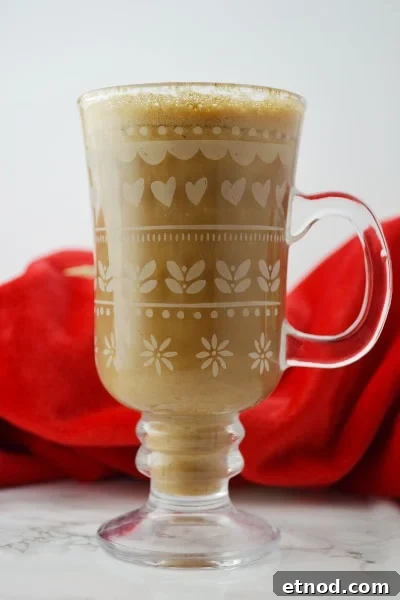 banana-milk-coffee- www-insidetherustickitchen-com Banana milk coffee in a glass mug on a white surface