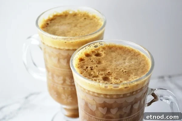 banana-milk-coffee- www-insidetherustickitchen-com Two glasses of banana milk coffee on a white surface