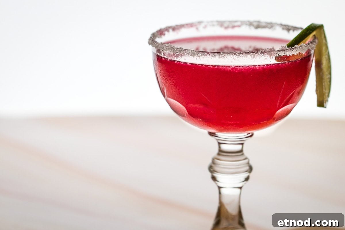 Hibiscus Margarita with a sugared rim and lime wedge