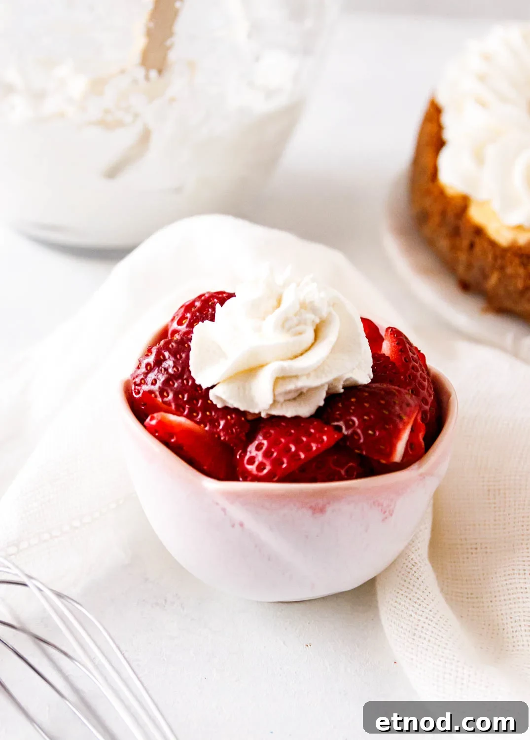 Serving suggestion image showing a bowl of strawberries with whipped cream.