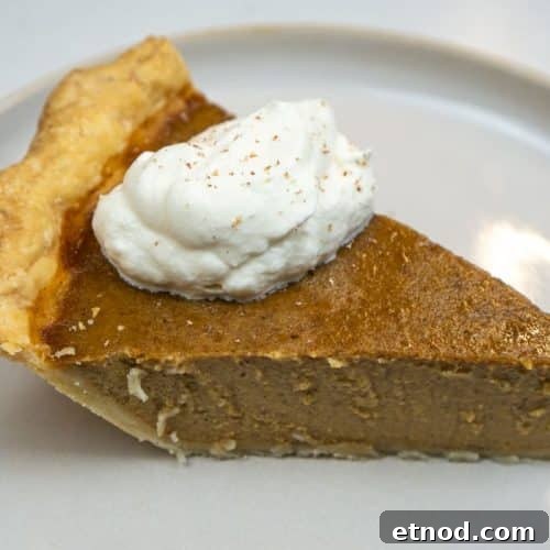 Slice of Pumpkin Pie Served With Fresh Cream
