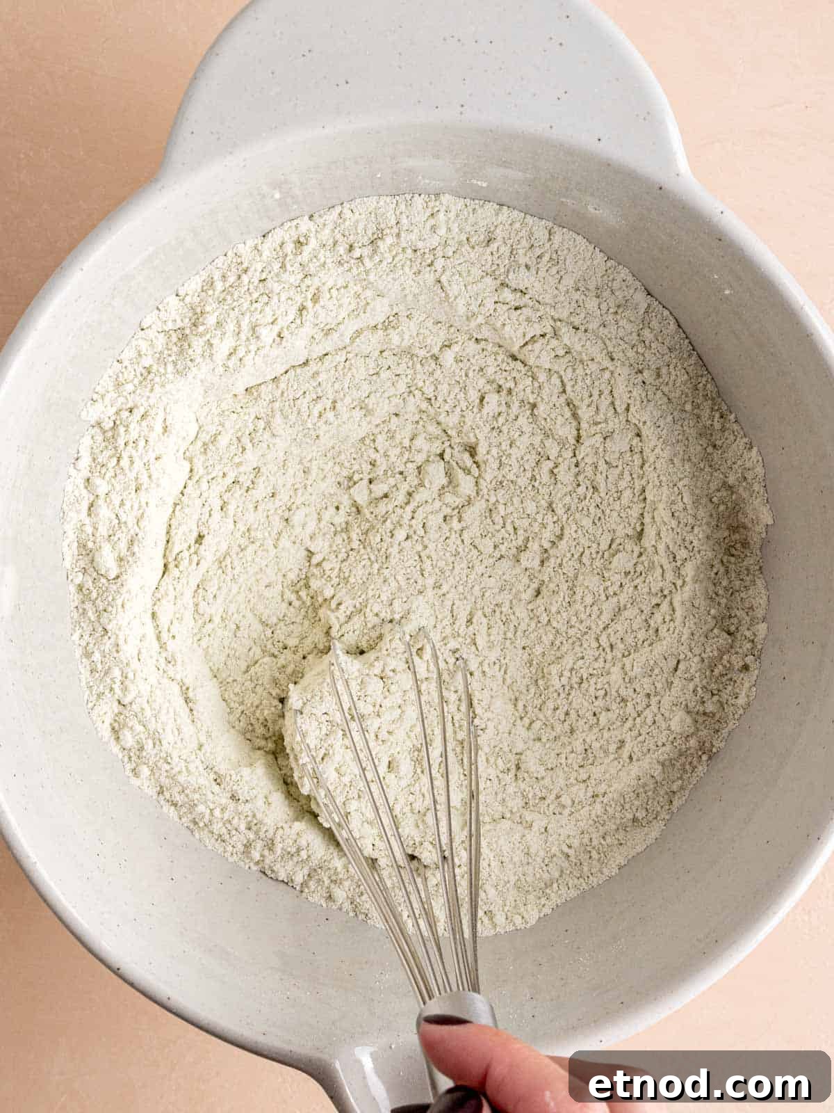 Matcha Muffins with White Chocolate Chips: Soft & Moist Recipe 4 Whisking flour, matcha powder, sugar, baking powder, and salt in a bowl.
