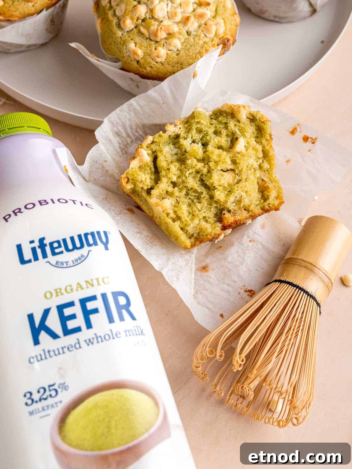 Matcha Muffins with White Chocolate Chips: Soft & Moist Recipe 8 Half of a white chocolate chip matcha muffin next to a bottle of Lifeway Matcha Kefir.