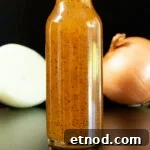 Subway Sweet Onion Sauce: Flavor, Ingredients & How It's Made 6 A small glass bottle filled with brown copycat subway sweet onion sauce is in focus. A sliced and unsliced onion are out of focus in the background.