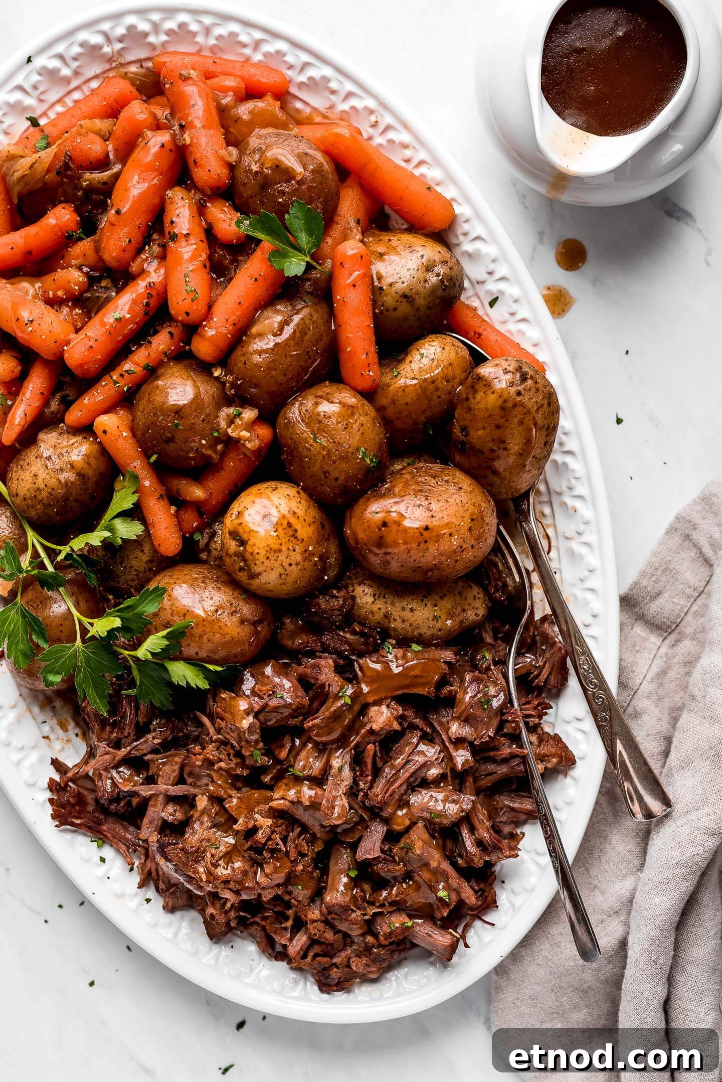 A large patter of Pressure Cooker Pot Roast, potatoes, and carrots.