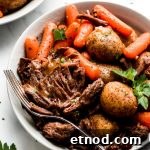 Instant Pot Pot Roast in a bowl with carrots, and baby yukon potatoes.