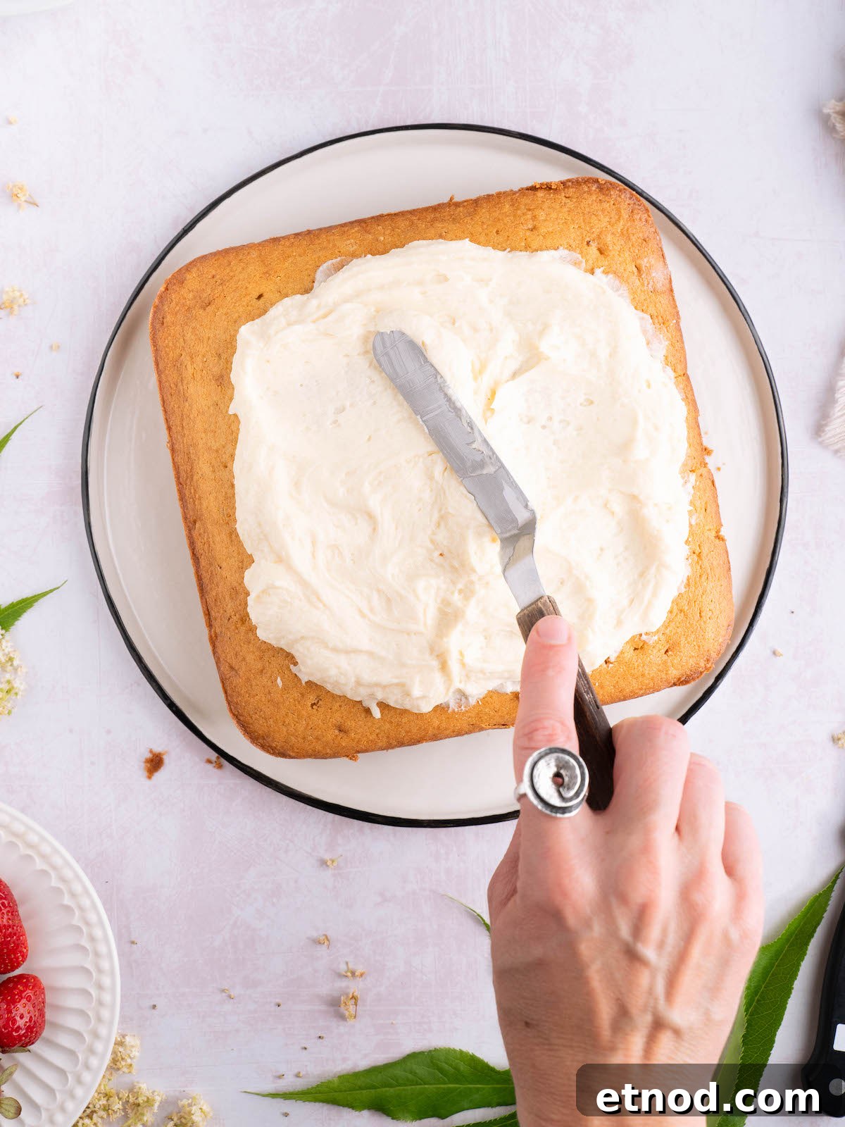 Frosting a cake with elderflower buttercream