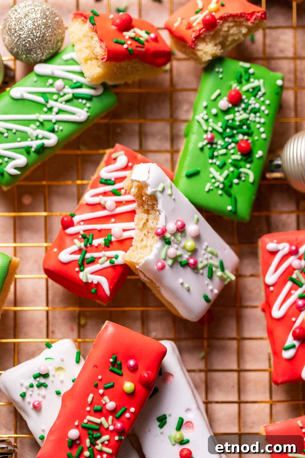 Chewy Christmas Sugar Cookie Bars with Festive Sprinkles 2 Christmas sugar cookie bars with festive sprinkles on a gold wire rack.