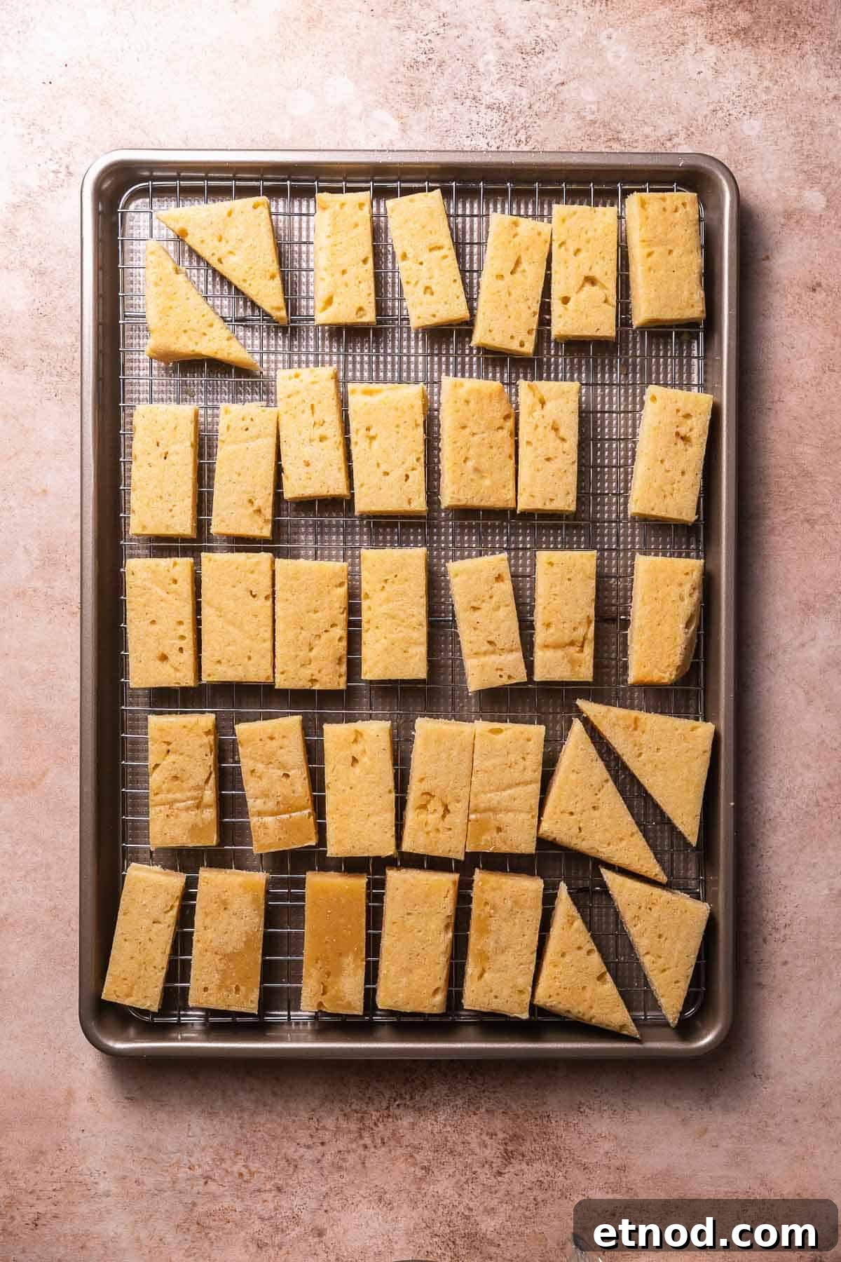 Chewy Christmas Sugar Cookie Bars with Festive Sprinkles 7 Cut sugar cookie bars on a wire rack and sheet pan.