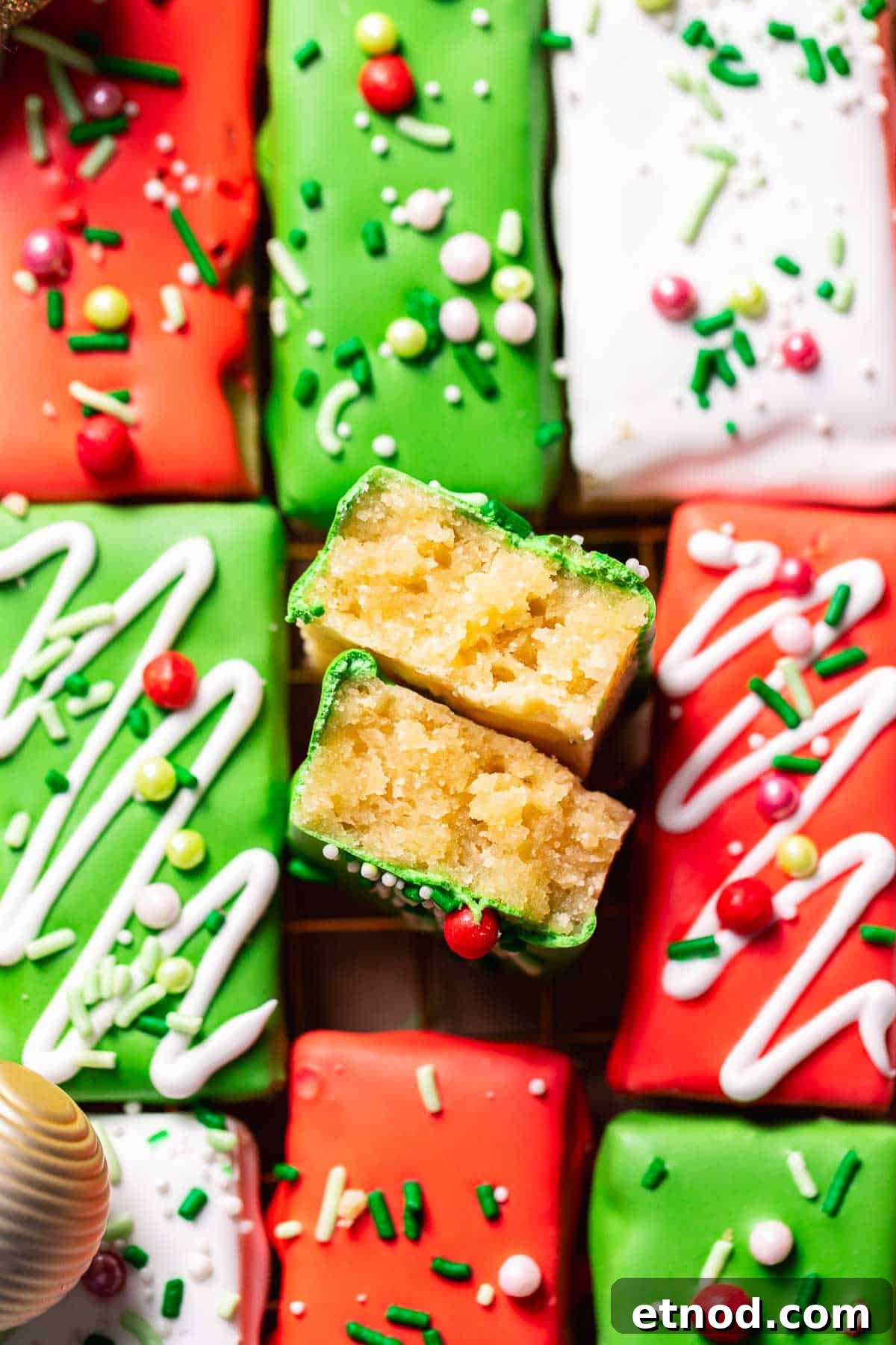 Chewy Christmas Sugar Cookie Bars with Festive Sprinkles 10 Frosted sugar cookie bar broken in half to show the soft and chewy texture.