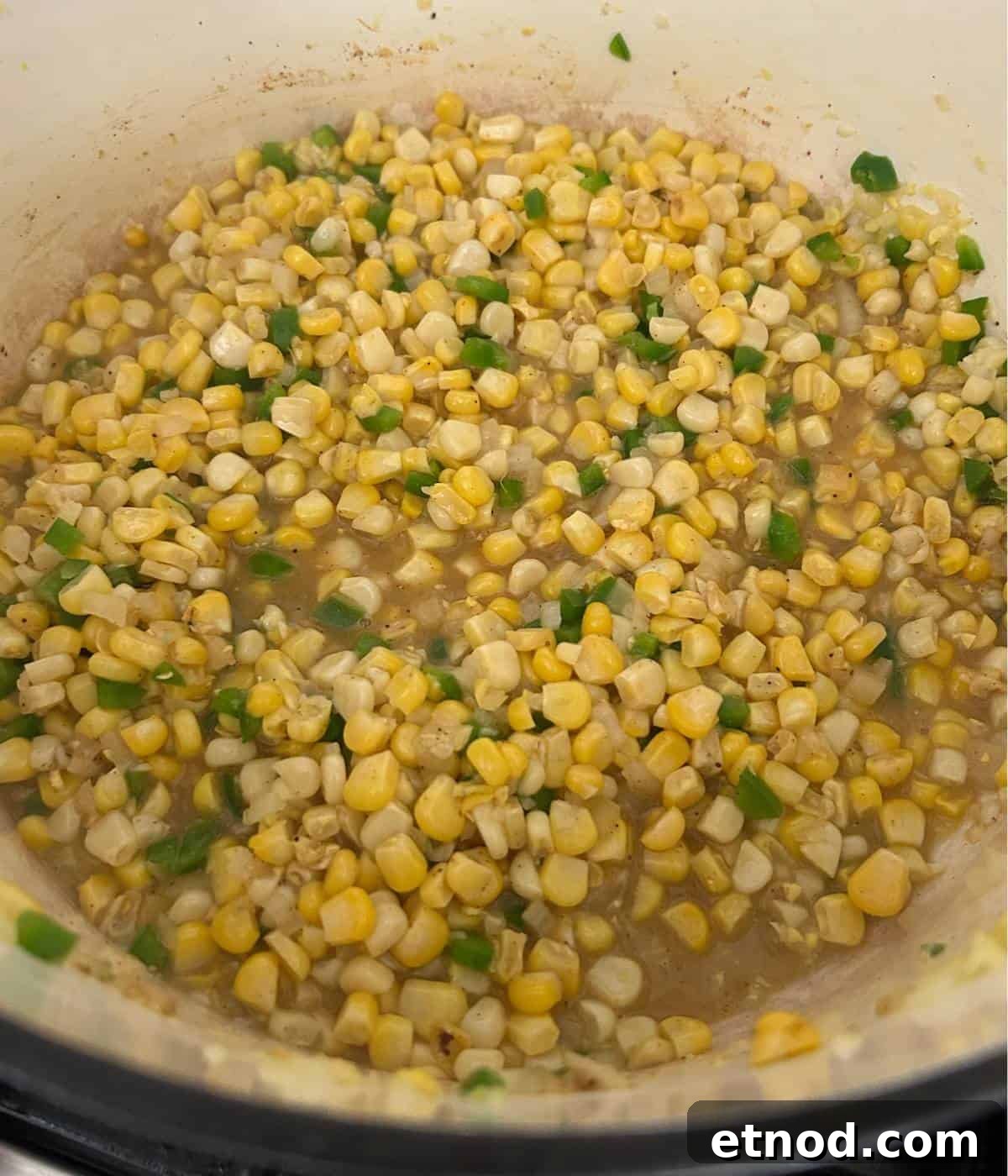 Corn with jalapeños in dutch oven.