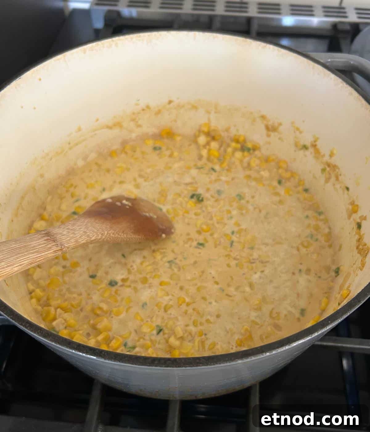 Corn and jalapeños cooking in pot.