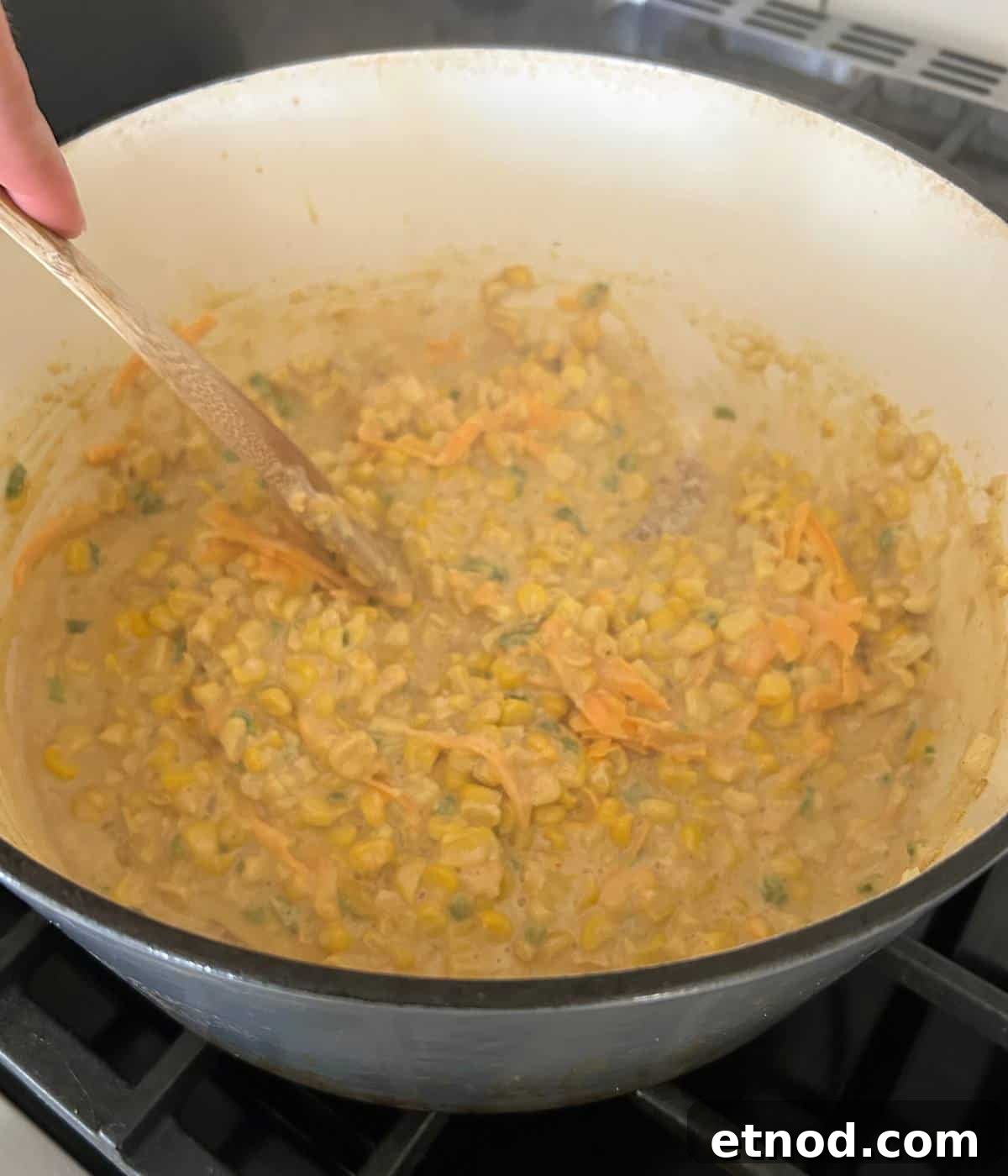 Creamed corn in pot.