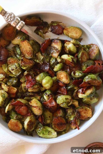 Balsamic Glaze Brussels sprouts in white bowl with serving spoon.